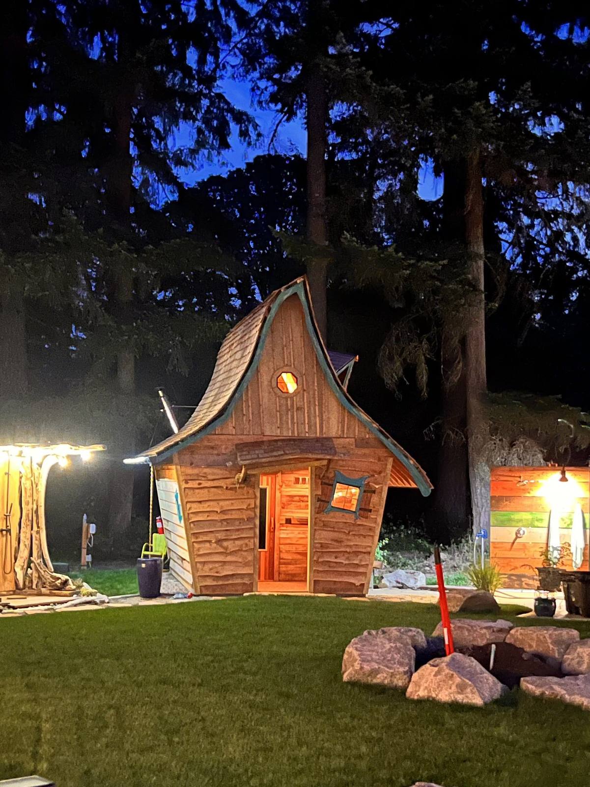 The hand-built sauna up close, glowing at twilight